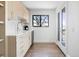 Modern kitchenette with shaker cabinets, hardwood floors and a large window at 2524 Zenobia St, Denver, CO 80212