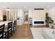 Open-concept living room with hardwood floors, a fireplace, and stylish decor at 2524 Zenobia St, Denver, CO 80212