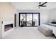 Spacious main bedroom with a fireplace, a balcony with seating and lots of natural light at 2524 Zenobia St, Denver, CO 80212