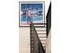 Contemporary staircase featuring sleek black railings and modern artwork adorning the wall at 2524 Zenobia St, Denver, CO 80212