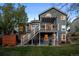 Large backyard featuring a deck with stairs, patio, and well-maintained lawn at 2042 Chesapeake Pl, Highlands Ranch, CO 80126