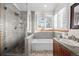 Bathroom featuring glass-enclosed shower, soaking tub, and vanity with countertop at 2042 Chesapeake Pl, Highlands Ranch, CO 80126