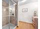 Bathroom featuring a glass shower cabin, wood floors and vanity with sink at 2042 Chesapeake Pl, Highlands Ranch, CO 80126