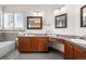 Well-lit bathroom featuring dual vanities and soaking tub with tile surround at 2042 Chesapeake Pl, Highlands Ranch, CO 80126