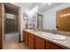 Bathroom featuring double sinks, granite countertops, and a separate shower cabin with a glass door at 2042 Chesapeake Pl, Highlands Ranch, CO 80126