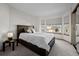 Bedroom featuring bay windows, carpet flooring, and a king-sized bed at 2042 Chesapeake Pl, Highlands Ranch, CO 80126