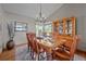 Cozy dining room with wood table, chairs, hutch, and a window with natural light at 2042 Chesapeake Pl, Highlands Ranch, CO 80126