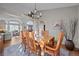 Warm dining room featuring a wood table, chandelier, and view into the living room at 2042 Chesapeake Pl, Highlands Ranch, CO 80126