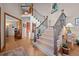 Welcoming entryway with wood floors, an elegant staircase, and natural light at 2042 Chesapeake Pl, Highlands Ranch, CO 80126
