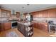 Well-lit kitchen with stainless steel appliances, wooden cabinetry, and center island at 2042 Chesapeake Pl, Highlands Ranch, CO 80126