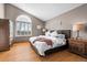 Cozy bedroom with vaulted ceiling, window, and hardwood floors at 2042 Chesapeake Pl, Highlands Ranch, CO 80126