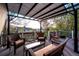 Covered patio area with cushioned seating, coffee table, and neighborhood views at 2042 Chesapeake Pl, Highlands Ranch, CO 80126