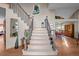 Inviting foyer featuring a staircase with wood and metal banisters, leading to the upper level at 2042 Chesapeake Pl, Highlands Ranch, CO 80126