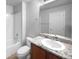Bathroom with granite vanity and white fixtures at 5242 Longs Peak St, Brighton, CO 80601