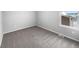Spacious carpeted bedroom with large window at 5242 Longs Peak St, Brighton, CO 80601