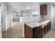 Kitchen features granite countertops and dark wood cabinets at 5242 Longs Peak St, Brighton, CO 80601