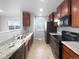Kitchen with granite countertops and dark wood cabinets at 5242 Longs Peak St, Brighton, CO 80601