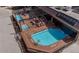 Aerial view of a rooftop pool and lounge area with seating and hot tubs, perfect for outdoor relaxation at 405 Village Rd # 101, Breckenridge, CO 80424