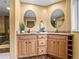 Elegant bathroom featuring a dual sink vanity with granite counters and oval mirrors at 405 Village Rd # 101, Breckenridge, CO 80424