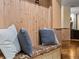 Cozy mudroom bench with decorative pillows and a colorful patterned cushion on wood floors at 405 Village Rd # 101, Breckenridge, CO 80424