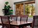 Dining area with a wood table, and a view of a stone wall and surrounding trees at 405 Village Rd # 101, Breckenridge, CO 80424