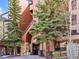 Inviting building entrance with stone columns, mature trees, and covered entryway at 405 Village Rd # 101, Breckenridge, CO 80424