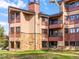Attractive condo building with stone facade, balconies, and manicured green lawn at 405 Village Rd # 101, Breckenridge, CO 80424