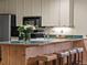 Charming kitchen island with wood paneling, seating, and a neutral color scheme at 405 Village Rd # 101, Breckenridge, CO 80424