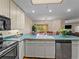 Bright kitchen showcasing an island, modern appliances, and a view into the dining area at 405 Village Rd # 101, Breckenridge, CO 80424