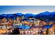 Picturesque night view of a charming mountain town with snow-capped peaks in the background at 405 Village Rd # 101, Breckenridge, CO 80424