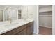 Double sink bathroom with a walk-in shower and closet at 7312 Watercress Dr, Littleton, CO 80125