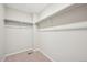 Walk-in closet with double hanging rods and neutral walls at 7312 Watercress Dr, Littleton, CO 80125