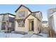 Two-story house with light beige siding and stone accents at 7312 Watercress Dr, Littleton, CO 80125