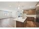 Modern kitchen with island, stainless steel appliances, and light wood cabinets at 7312 Watercress Dr, Littleton, CO 80125