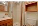 Clean basement bathroom with shower and wooden vanity at 1455 S Vaughn Cir, Aurora, CO 80012