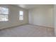 Spacious carpeted bedroom with two windows at 1455 S Vaughn Cir, Aurora, CO 80012