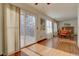 Bright dining room with hardwood floors, fireplace, and access to deck at 1455 S Vaughn Cir, Aurora, CO 80012