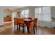 Dining area with hardwood floors and a rustic wooden table at 1455 S Vaughn Cir, Aurora, CO 80012