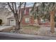 Two-story home with brick and siding exterior, and a rock garden at 1455 S Vaughn Cir, Aurora, CO 80012