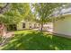 Spacious backyard featuring lush green lawn, mature trees, and a well-maintained garden area at 331 Sherman St, Longmont, CO 80501