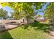 A spacious backyard features a stone patio with dining area and lush green lawn, perfect for outdoor entertaining at 331 Sherman St, Longmont, CO 80501