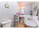 Charming bathroom featuring a clawfoot tub, pedestal sink, and vintage-inspired decor at 331 Sherman St, Longmont, CO 80501