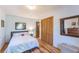 Cozy bedroom featuring hardwood floors, light blue walls, and a comfortable bed with decorative pillows at 331 Sherman St, Longmont, CO 80501