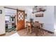 Cozy dining room features a wood table, hardwood floors, and unique sliding barn door to an adjacent room at 331 Sherman St, Longmont, CO 80501