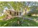 Charming home featuring a quaint front porch, lush lawn, and mature trees providing ample shade at 331 Sherman St, Longmont, CO 80501