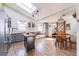 Open kitchen with a skylight, stainless steel appliances, and hardwood floors flowing into the dining area at 331 Sherman St, Longmont, CO 80501