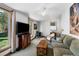 This open living room features plentiful natural light, a wood-burning stove, and cozy seating at 331 Sherman St, Longmont, CO 80501