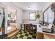 Bright home office with built-in desk, cheery checkerboard floor, and view into the dining and living areas at 331 Sherman St, Longmont, CO 80501