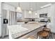 Bright kitchen featuring granite counters, stainless appliances, white cabinets and island seating at 8481 Dawson Dr, Denver, CO 80229