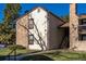 Charming condo with a mix of stone and siding, complemented by well-maintained landscaping and a clear blue sky at 7790 W 87Th Drive Dr # D, Arvada, CO 80005
